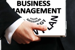 Picture of a man carrying a business management folder
